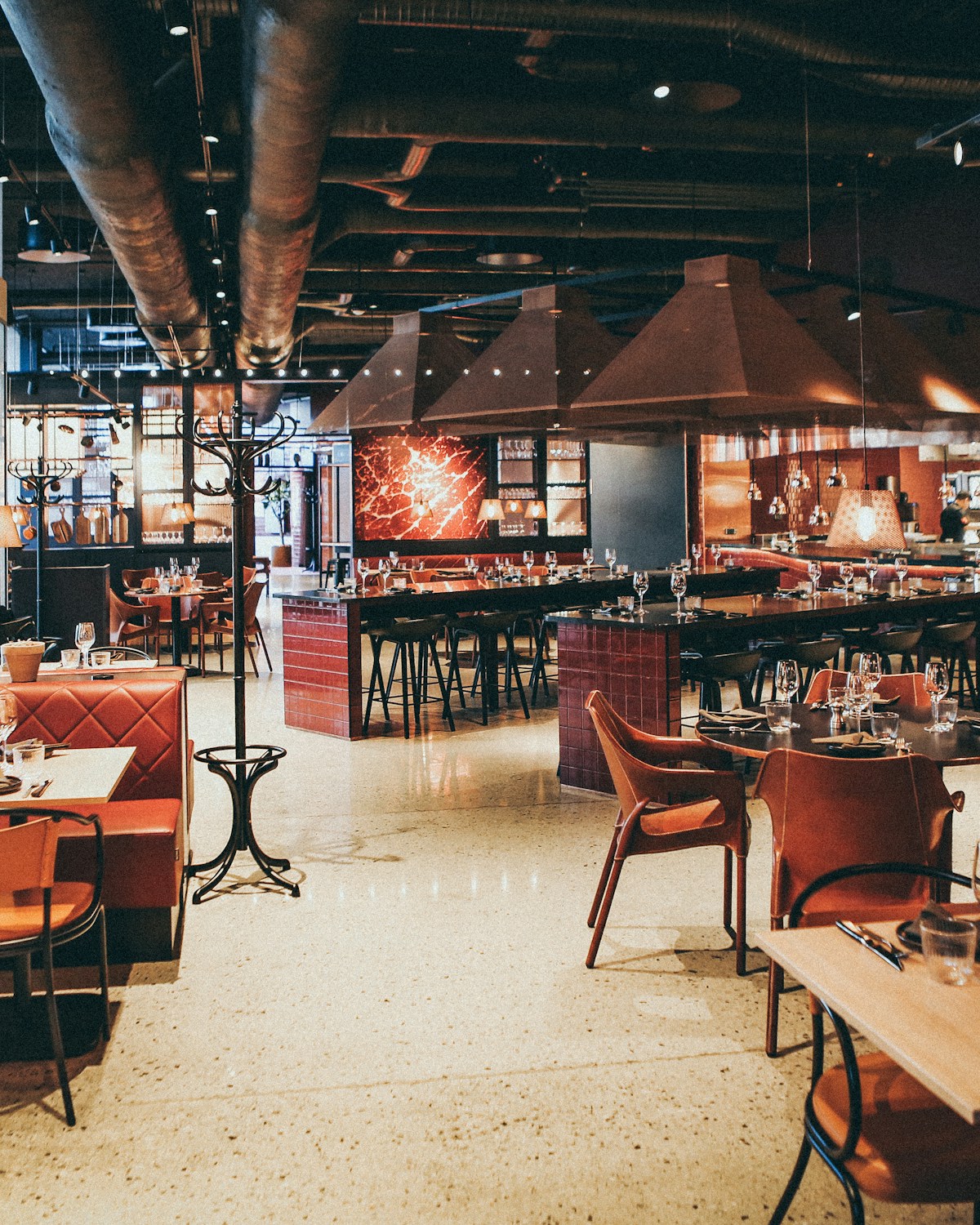 Server welcoming happy guests at a busy restaurant — repeat customers